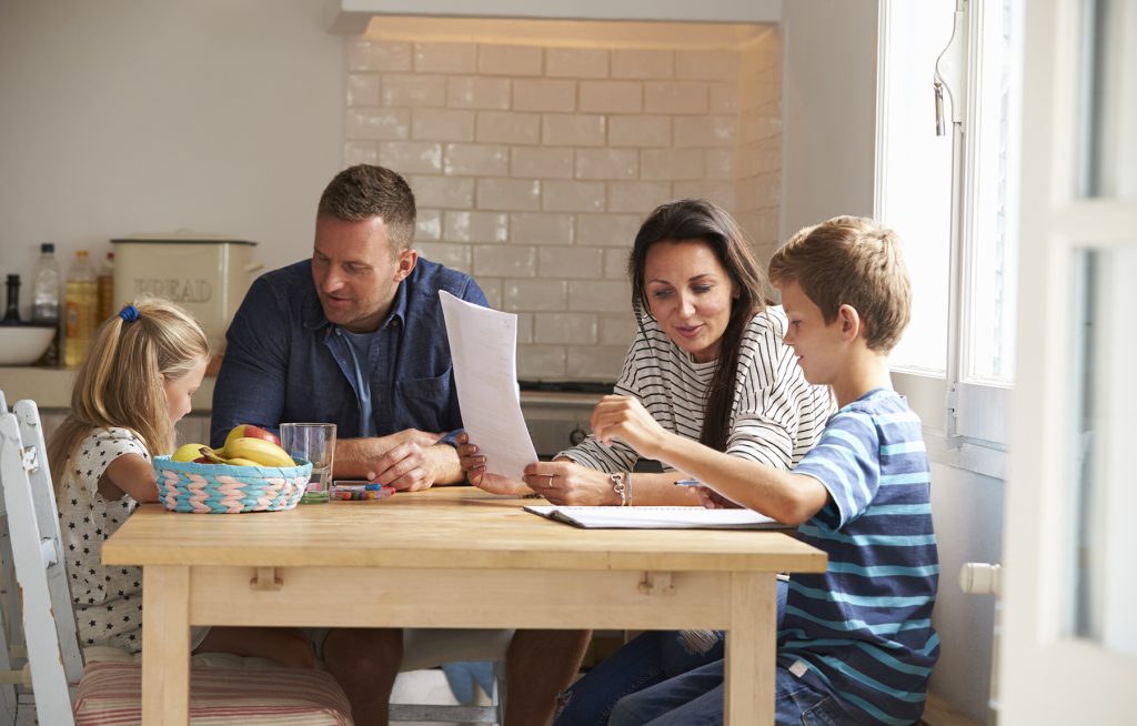 family sitting at kitchen table crafting a mission statement