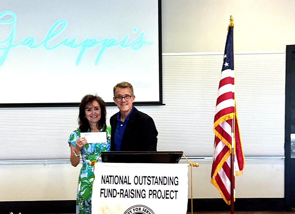 CHI CEO Dr. Sandy Munoz receiving a donation check from the Exchange Club of Pompano Beach